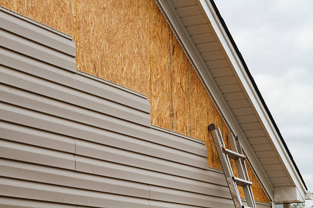 Professional Storm Damage Siding Repair technician working in Boxborough, MA